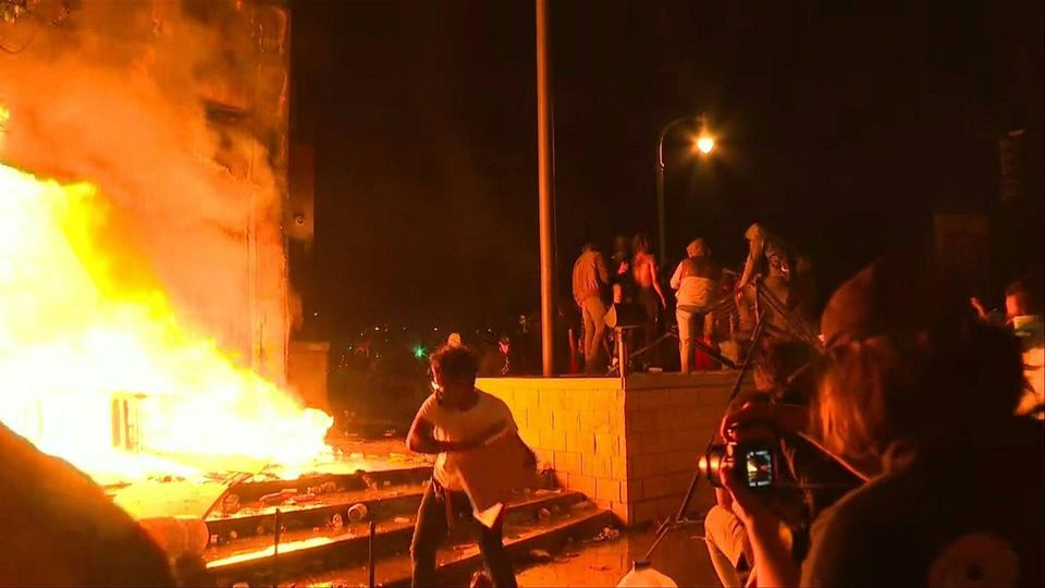 Protesters set Minneapolis police station on fire