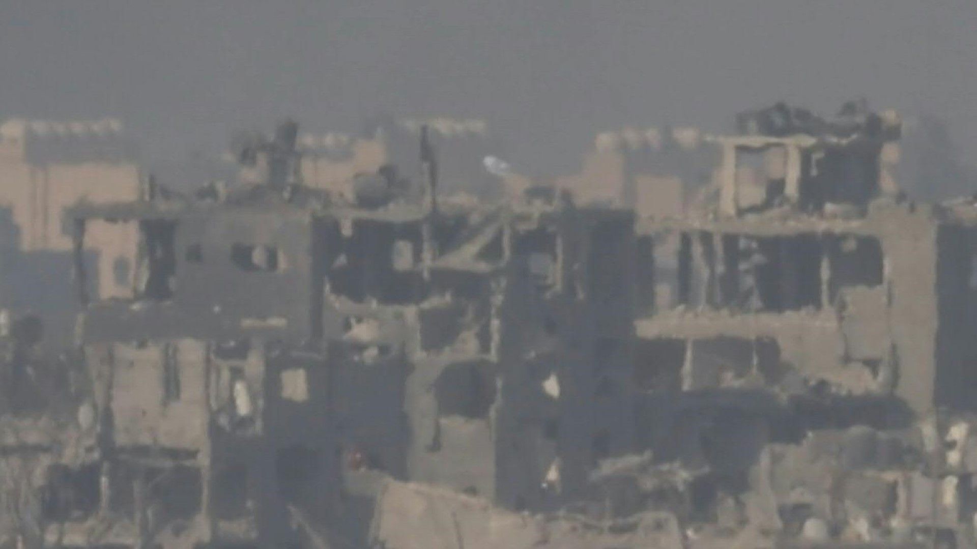 Israeli flag raised on top of destroyed building in northern Gaza