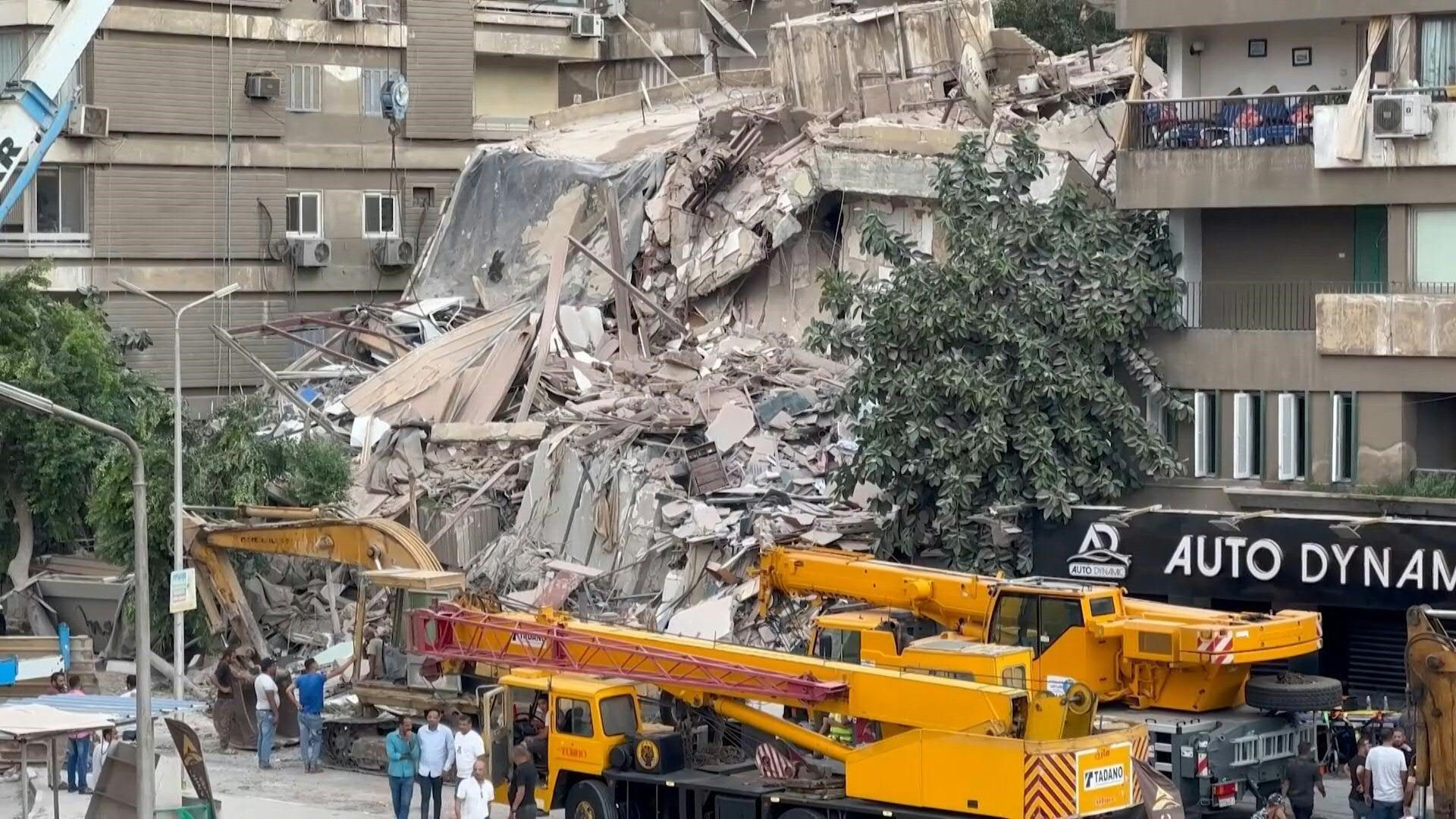 Emergency crews at the site where a building collapsed in Cairo