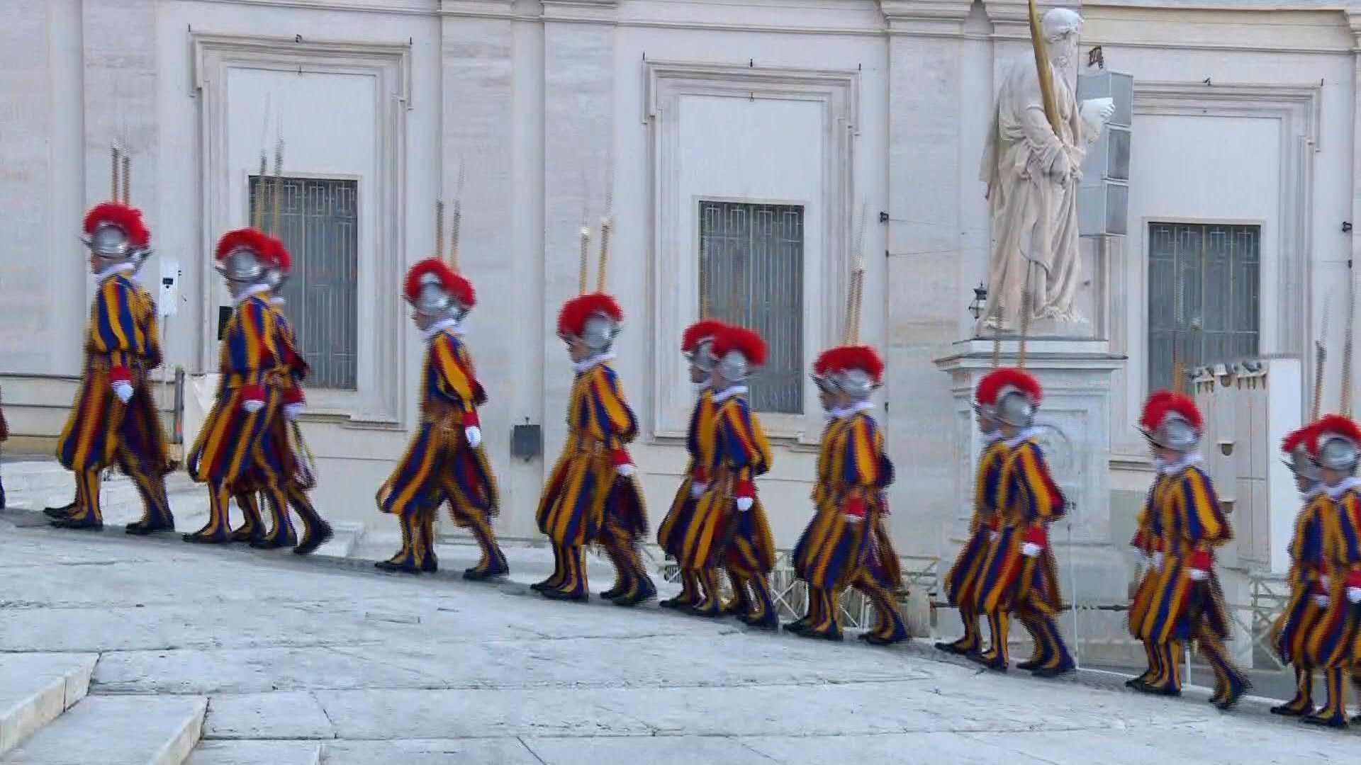 Swiss Guards and ceremonial band parade towards St. Peter's Basilica