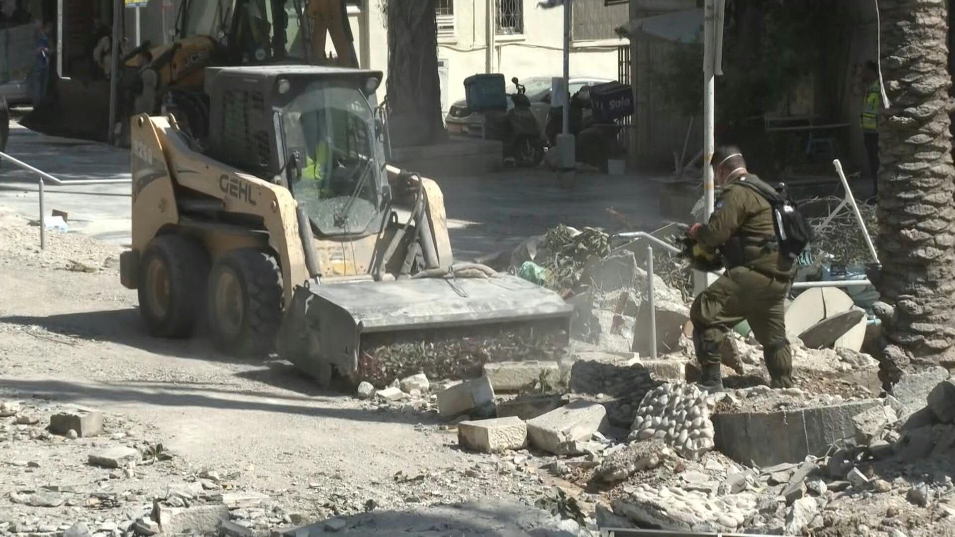 Israeli first responders clear rubble in Haifa after Iran missile attack