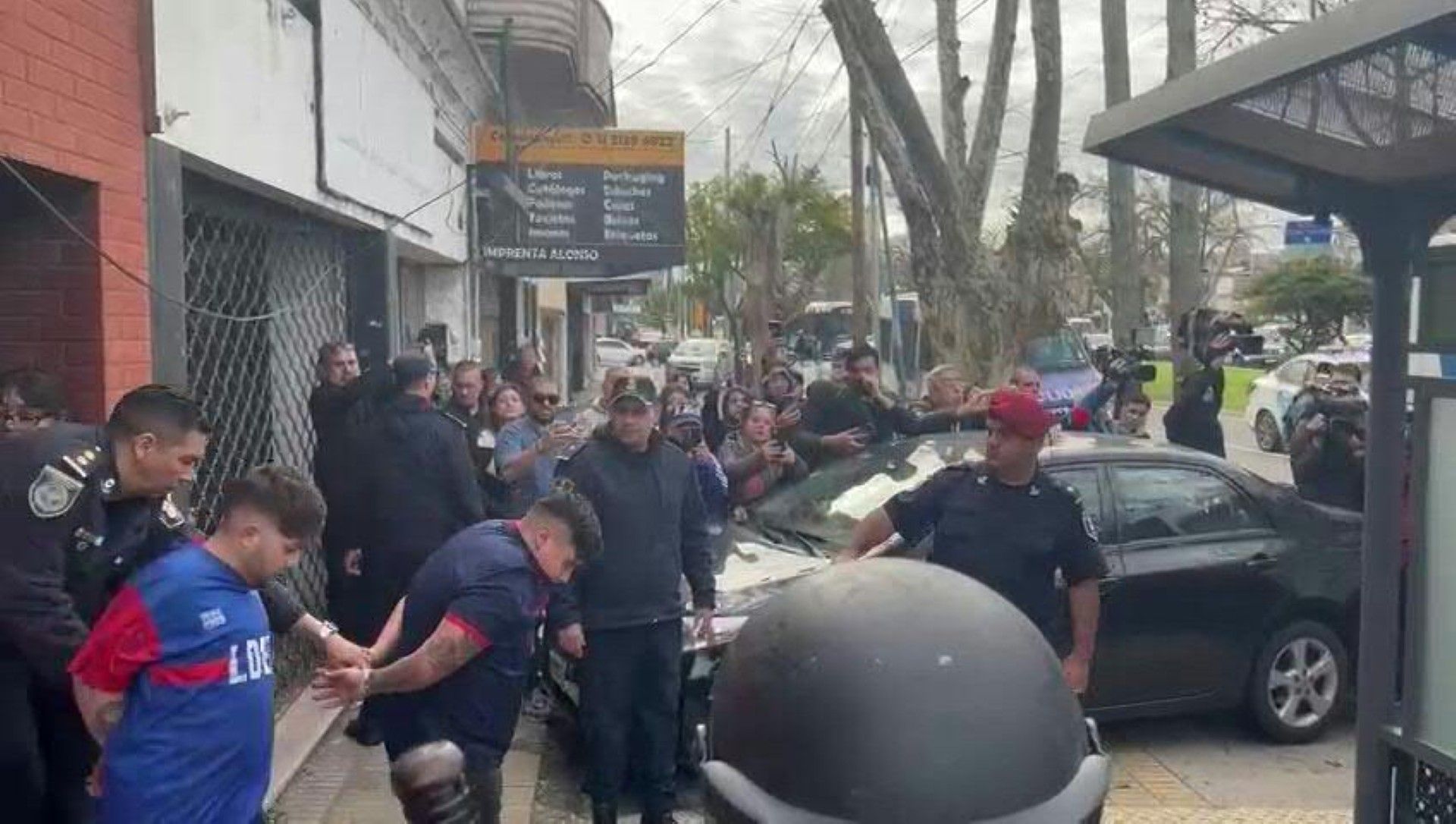 Football fans detained during violent clashes escorted out of a Buenos Aires police station