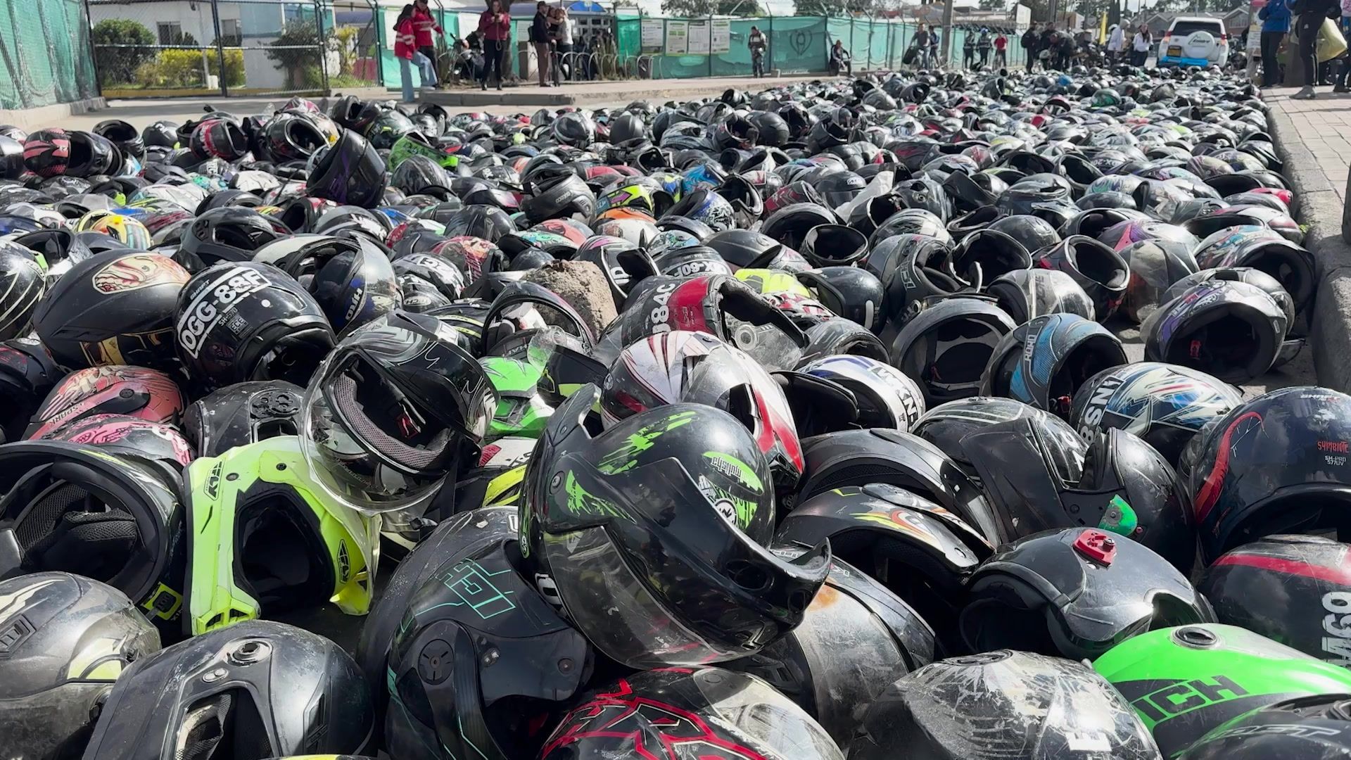 Motorcyclists lay hundreds of helmets in Bogota to protest against transport policies