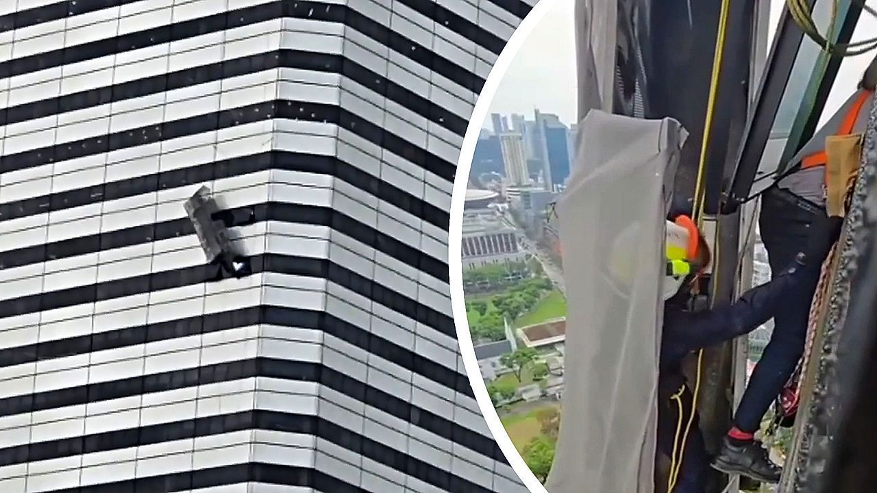 Video: Schiefe Arbeitsbühne am 26. Stock: Fensterputzer in Singapur hängen in der Luft