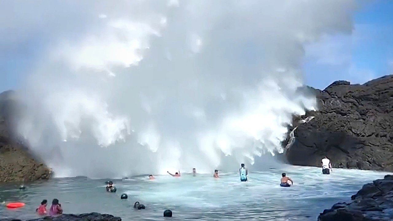 Video: Tourists play in lagoon as 60ft high waves crash onto rocks in the Philippines