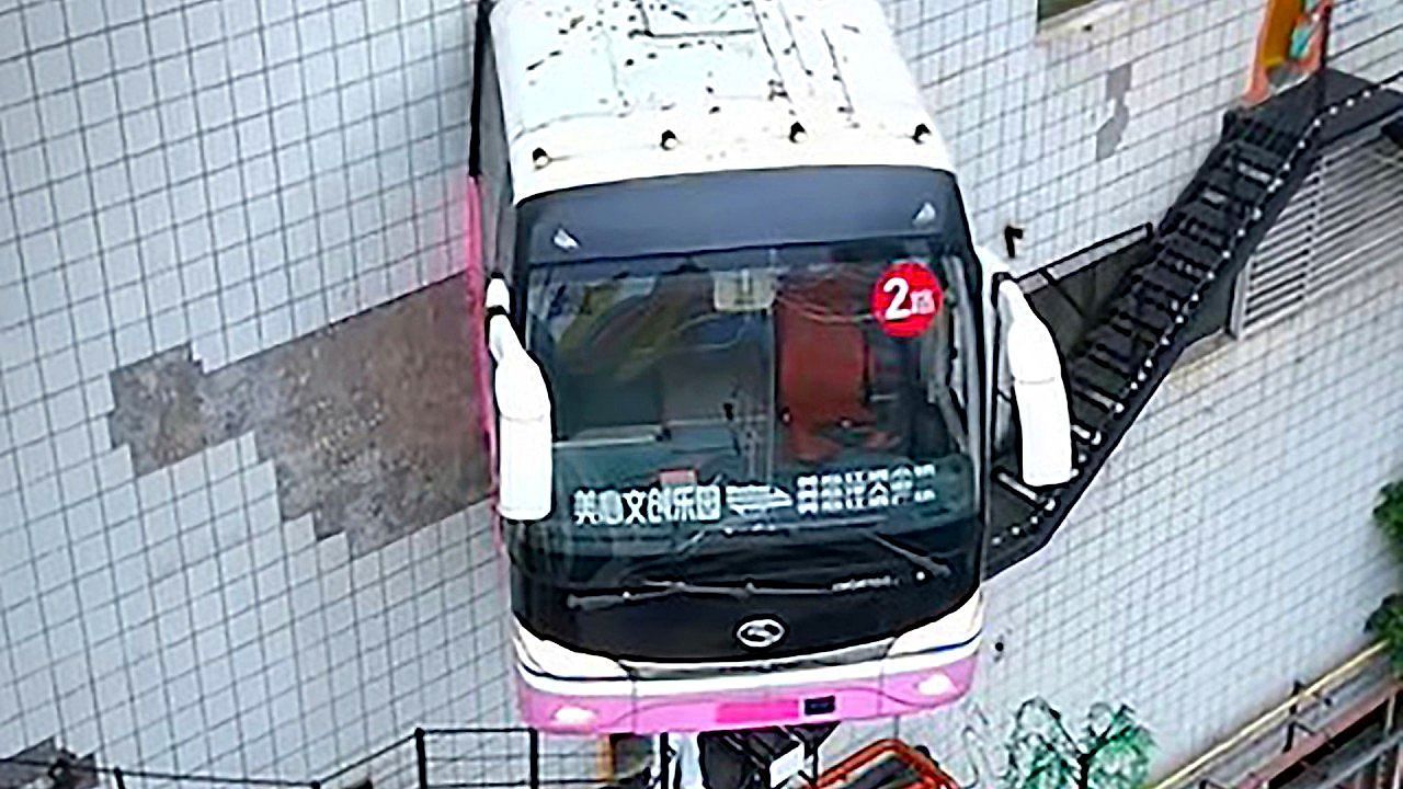 Bus-appears-to-burst-through-buildings-in-striking-display