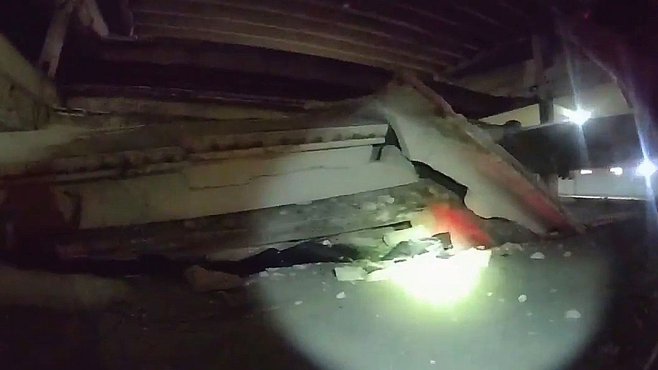 Video: Man survives uninjured after parking garage collapses on his car